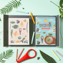 Load image into Gallery viewer, Schylling Tiger Tribe Outdoor Activity Set Back to Nature opened with magnifying glass, 6 rainbow chalk, a pencil, and activity book.
