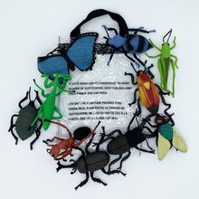 Load image into Gallery viewer, Wild Republic 10-piece educational toy insect collection of large realistic insects out of and around clear zipper bag.