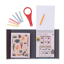 Load image into Gallery viewer, Schylling Tiger Tribe Outdoor Activity Set Back to Nature opened with magnifying glass, 6 rainbow chalk, a pencil, and activity book.
